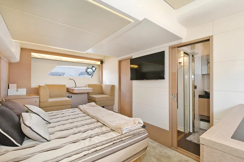 Slide: The Image of Luxurious interior of 2018 Prestige 560 Fly yacht with modern bedroom and seating area. - 44