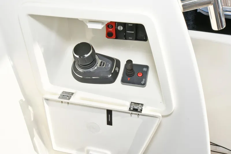 Slide: The Image of Control panel of a 2018 Prestige 560 Fly yacht with joystick and switches. - 7