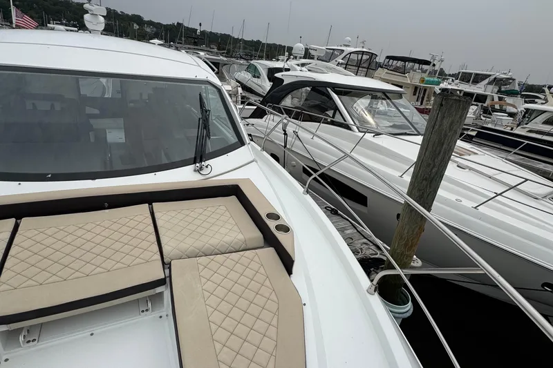 Slide: The Image of 2019 Cruisers Yachts 42 Cantius docked with luxurious seating and sleek design. - 10