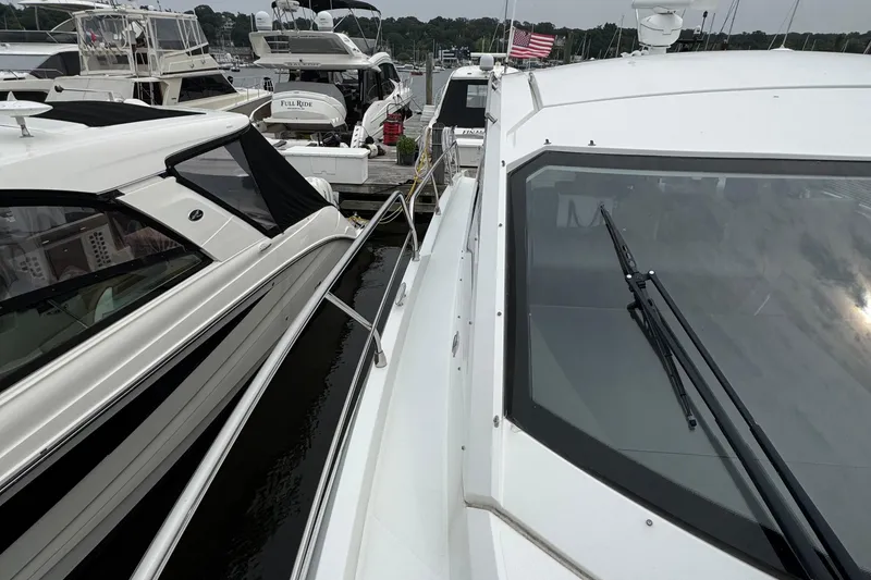 Slide: The Image of 2019 Cruisers Yachts 42 Cantius docked among other boats at a marina. - 11
