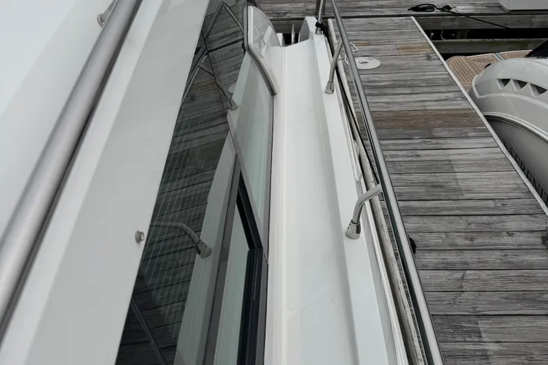 Slide: The Image of 2019 Cruisers Yachts 42 Cantius docked, showcasing sleek design and modern railings. - 12