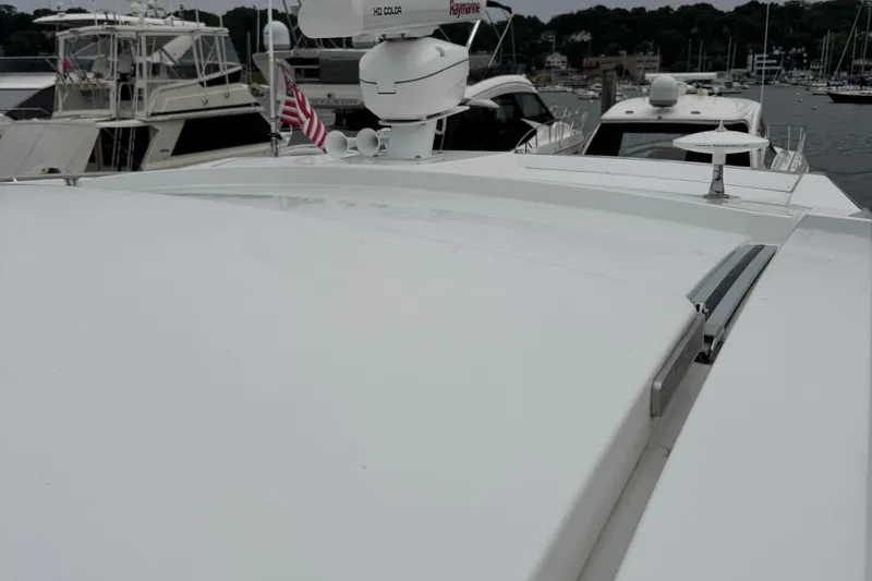 Slide: The Image of 2019 Cruisers Yachts 42 Cantius on a marina, showcasing sleek design and radar equipment. - 13