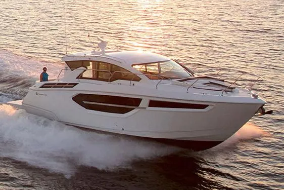 Slide: The Image of Manufacturer Provided Image: 2019 Cruisers Yachts 42 Cantius cruising on open water at sunset. - 2
