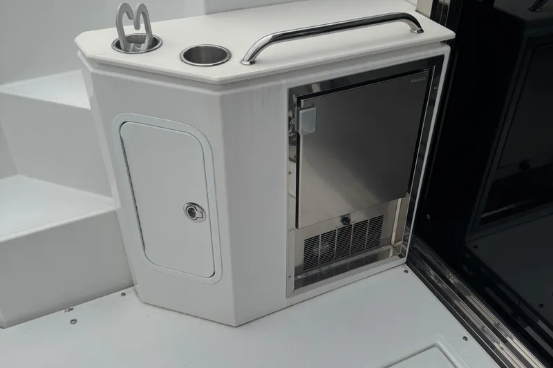 Slide: The Image of 2019 Cruisers Yachts 42 Cantius boat interior with stainless steel fridge and storage. - 24