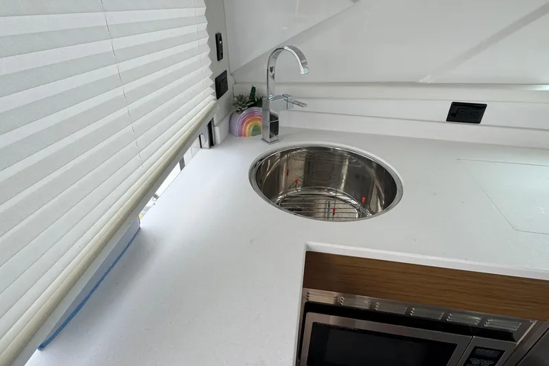 Slide: The Image of 2019 Cruisers Yachts 42 Cantius kitchen with modern sink and microwave. - 27