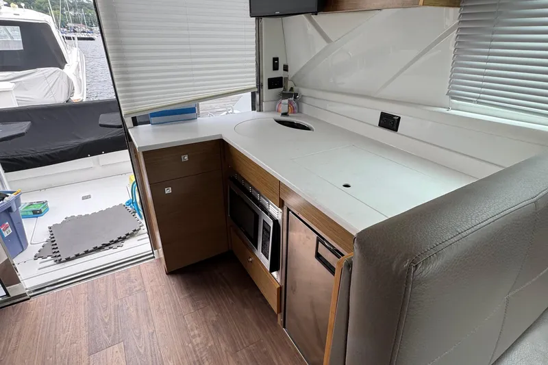 Slide: The Image of Interior of 2019 Cruisers Yachts 42 Cantius, featuring modern kitchen with appliances. - 28