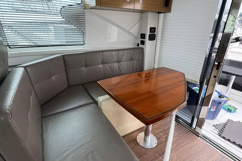 Slide: The Image of Luxurious interior of 2019 Cruisers Yachts 42 Cantius with leather seating and wooden table. - 29