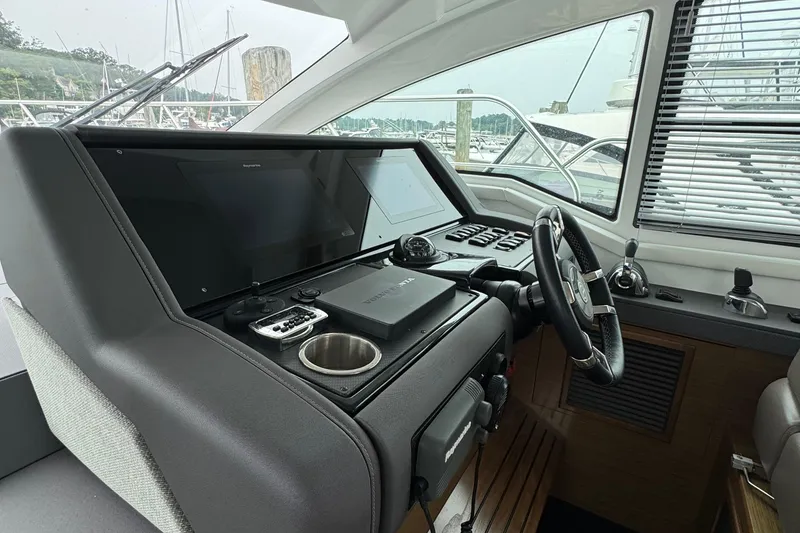 Slide: The Image of 2019 Cruisers Yachts 42 Cantius helm with modern navigation equipment and steering wheel. - 32