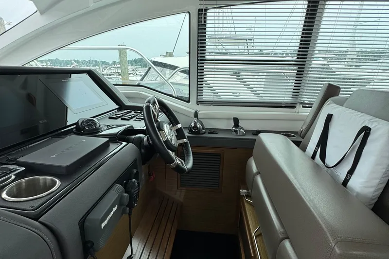 Slide: The Image of Interior helm of 2019 Cruisers Yachts 42 Cantius with modern controls and seating. - 34