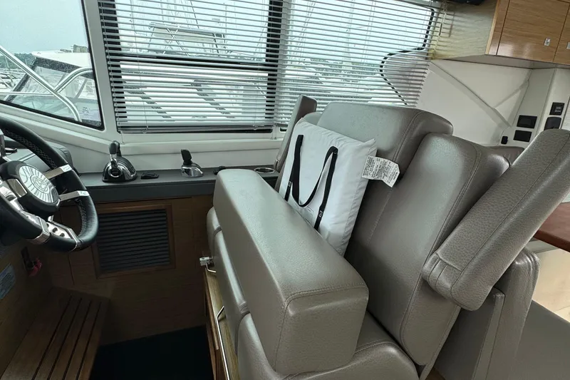 Slide: The Image of Interior of 2019 Cruisers Yachts 42 Cantius, featuring helm station and leather seating. - 37