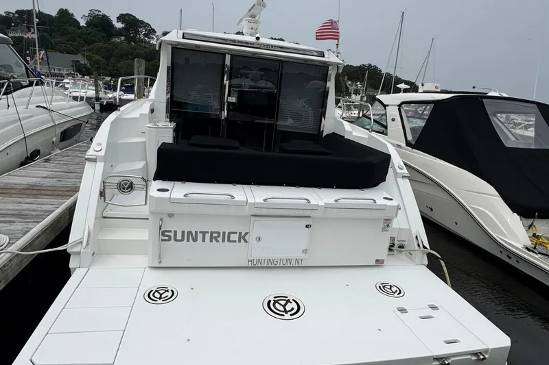 Slide: The Image of 2019 Cruisers Yachts 42 Cantius docked, rear view with American flag, Huntington, NY. - 4