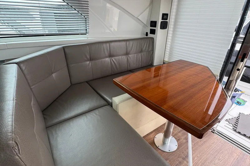Slide: The Image of Luxurious interior of 2019 Cruisers Yachts 42 Cantius with leather seating and wooden table. - 42