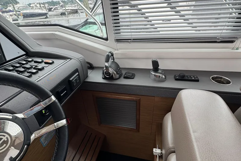 Slide: The Image of 2019 Cruisers Yachts 42 Cantius helm with steering wheel and control panel. - 44