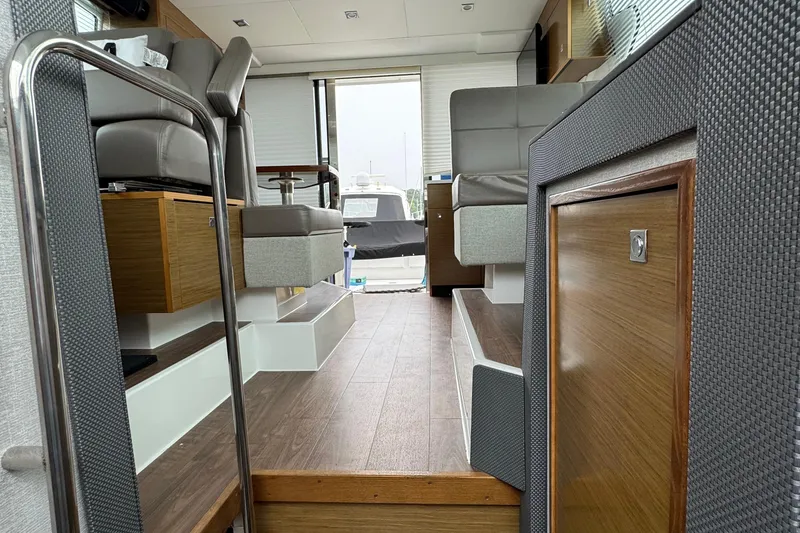 Slide: The Image of Interior of 2019 Cruisers Yachts 42 Cantius, featuring modern seating and wood accents. - 47