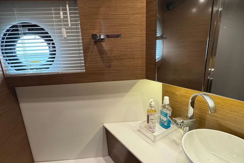 Slide: The Image of Luxurious bathroom interior of 2019 Cruisers Yachts 42 Cantius with modern sink and porthole. - 51