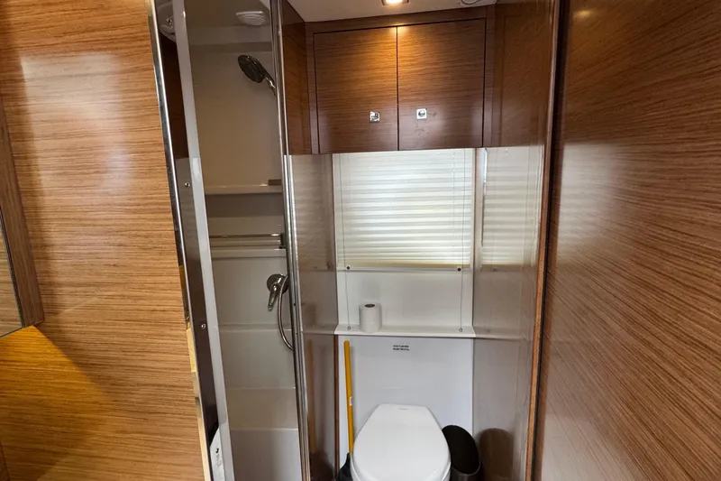 Slide: The Image of 2019 Cruisers Yachts 42 Cantius bathroom with wood paneling and modern fixtures. - 52