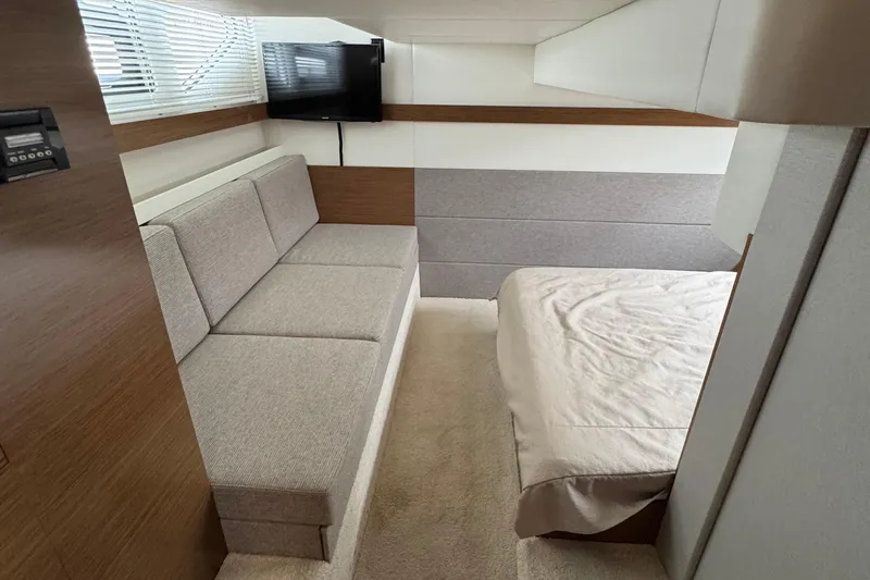 Slide: The Image of 2019 Cruisers Yachts 42 Cantius interior with sofa, bed, and wall-mounted TV. - 54