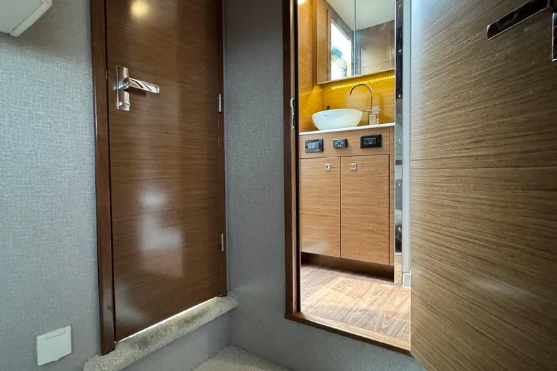 Slide: The Image of 2019 Cruisers Yachts 42 Cantius interior, featuring a modern bathroom with wood accents. - 58