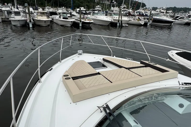 Slide: The Image of 2019 Cruisers Yachts 42 Cantius at marina, featuring bow sunpad and sleek design. - 7