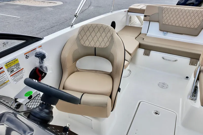 Slide: The Image of 2026 Bayliner VR6 boat interior with beige seating and steering wheel. - 10