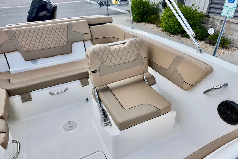 Slide: The Image of 2026 Bayliner VR6 boat interior with beige seating and modern design. - 12