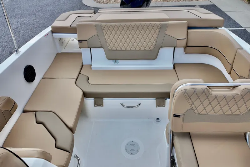 Slide: The Image of 2026 Bayliner VR6 boat interior with beige cushioned seating and diamond stitching. - 13