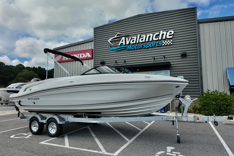 The Image of 2026 Bayliner VR6 boat on trailer at Avalanche Motorsports dealership. - 2