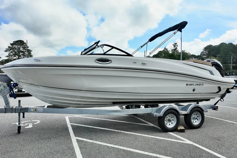 Slide: The Image of 2026 Bayliner VR6 boat on trailer in parking lot under cloudy sky. - 5