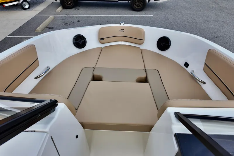 Slide: The Image of 2026 Bayliner VR6 boat interior with beige seating and speakers. - 7