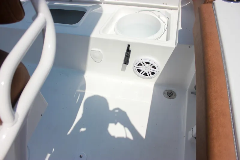 Slide: The Image of Interior of 2026 Sea Hunt Ultra 219 boat, featuring seating and speaker. - 11