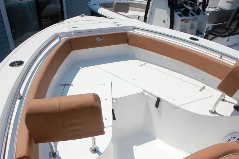 Slide: The Image of 2026 Sea Hunt Ultra 219 boat interior with tan seating and white deck. - 14