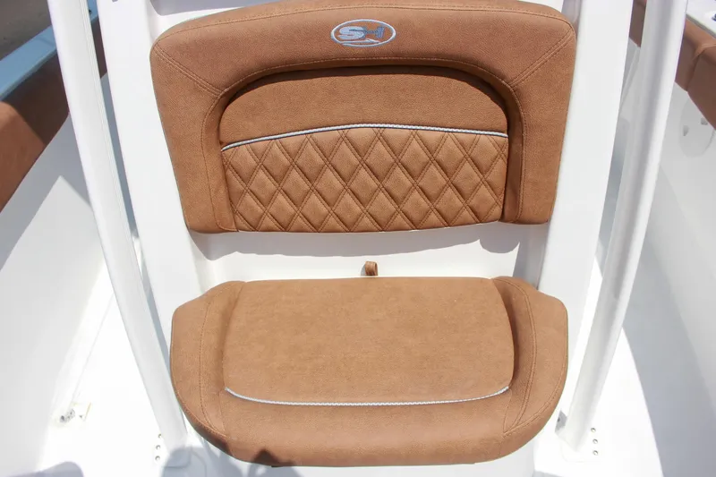 Slide: The Image of 2026 Sea Hunt Ultra 219 boat seat with brown cushioned upholstery and diamond stitching. - 17