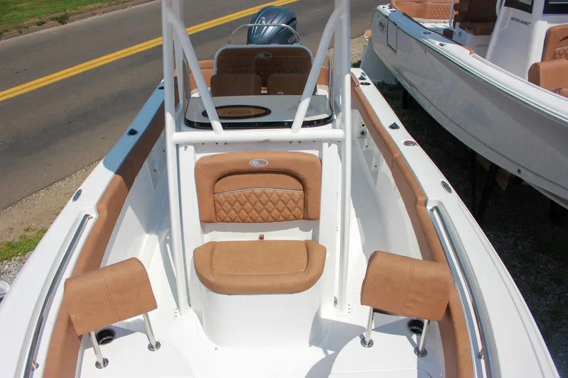 Slide: The Image of 2026 Sea Hunt Ultra 219 boat interior with tan seating and sleek design. - 20