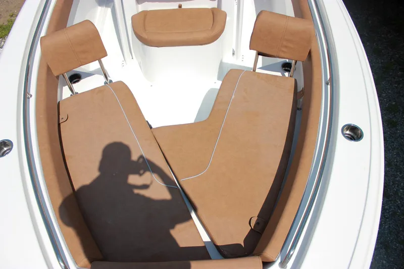 Slide: The Image of 2026 Sea Hunt Ultra 219 boat interior with tan seating and stainless steel accents. - 21