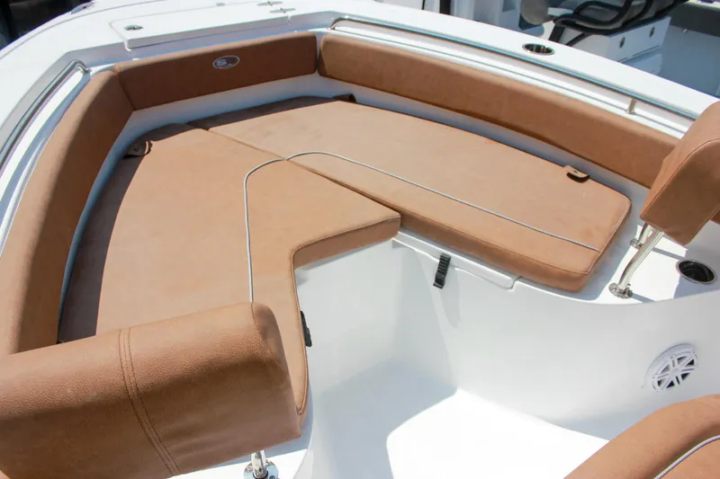 Slide: The Image of 2026 Sea Hunt Ultra 219 boat with tan cushioned seating in the bow area. - 22