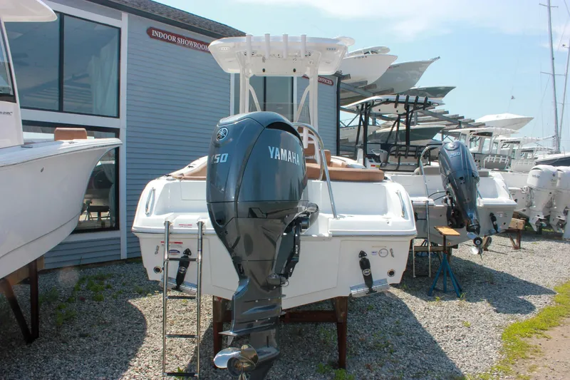 Slide: The Image of 2026 Sea Hunt Ultra 219 boat with Yamaha engine displayed outdoors. - 26