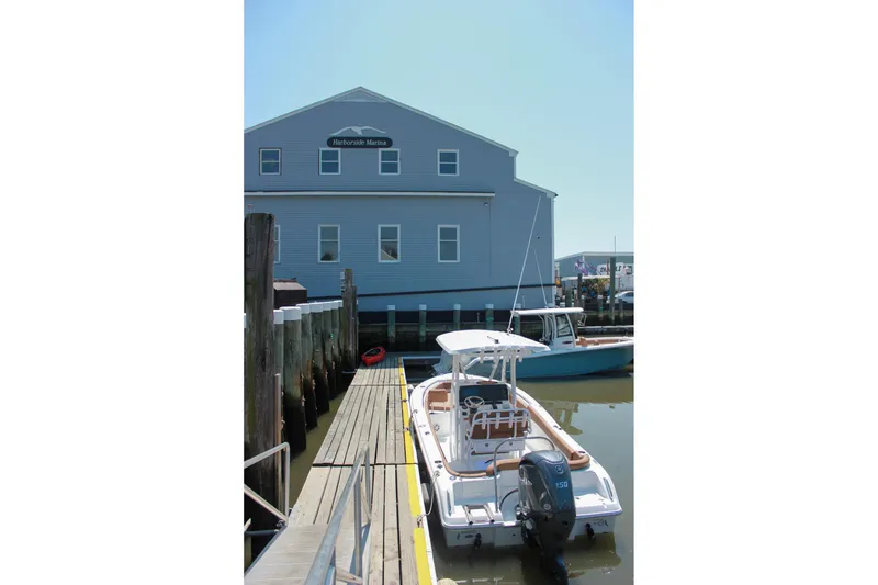 Slide: The Image of 2026 Sea Hunt Ultra 219 boat docked at Harborside Marina. - 30
