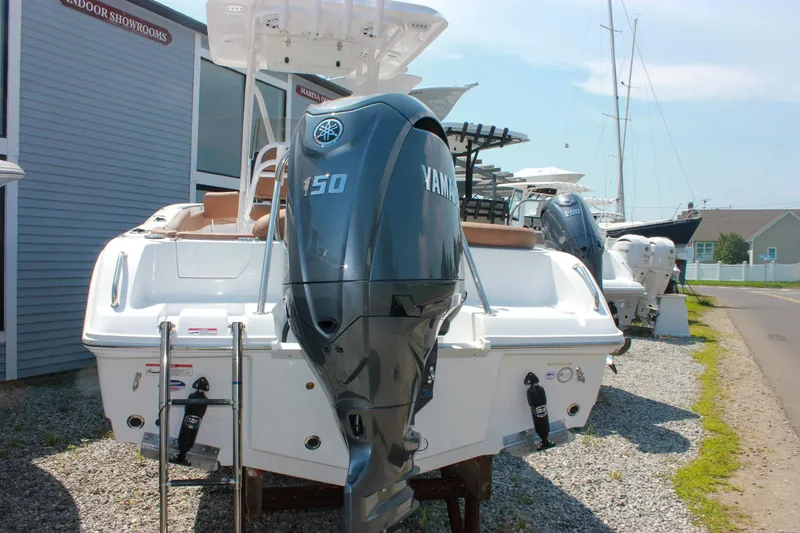 Slide: The Image of 2026 Sea Hunt Ultra 219 boat with Yamaha 150 engine at marina showroom. - 5