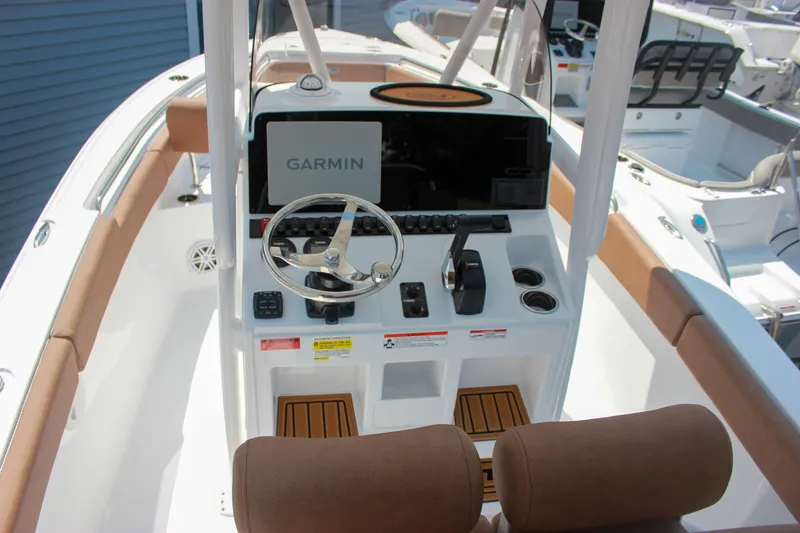 Slide: The Image of 2026 Sea Hunt Ultra 219 boat console with Garmin navigation system and steering wheel. - 6