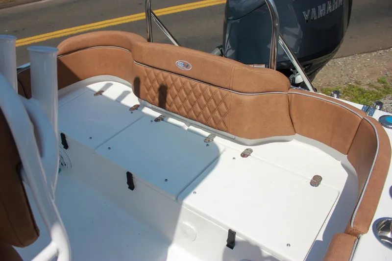 Slide: The Image of 2026 Sea Hunt Ultra 219 boat interior with tan cushioned seating and Yamaha engine. - 7