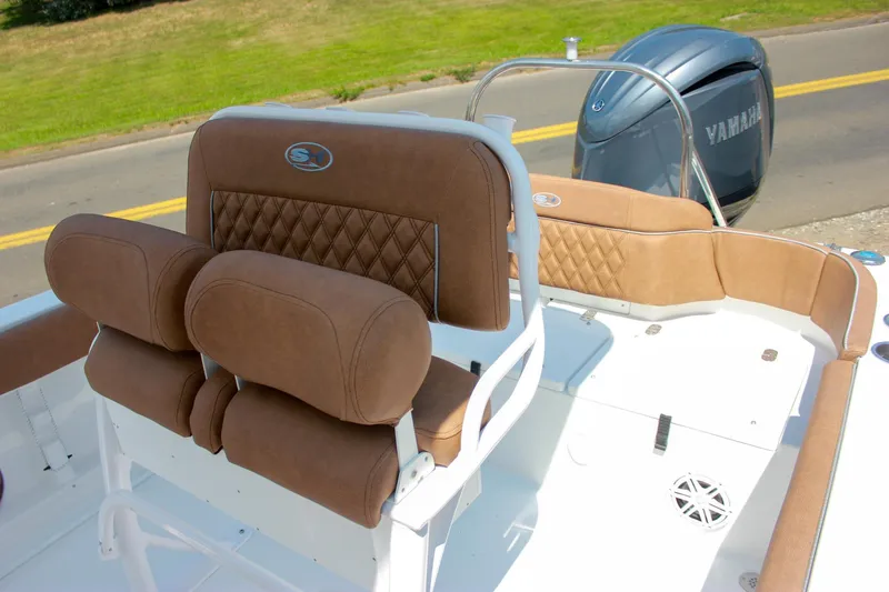 Slide: The Image of 2026 Sea Hunt Ultra 219 boat interior with brown cushioned seating and Yamaha engine. - 8