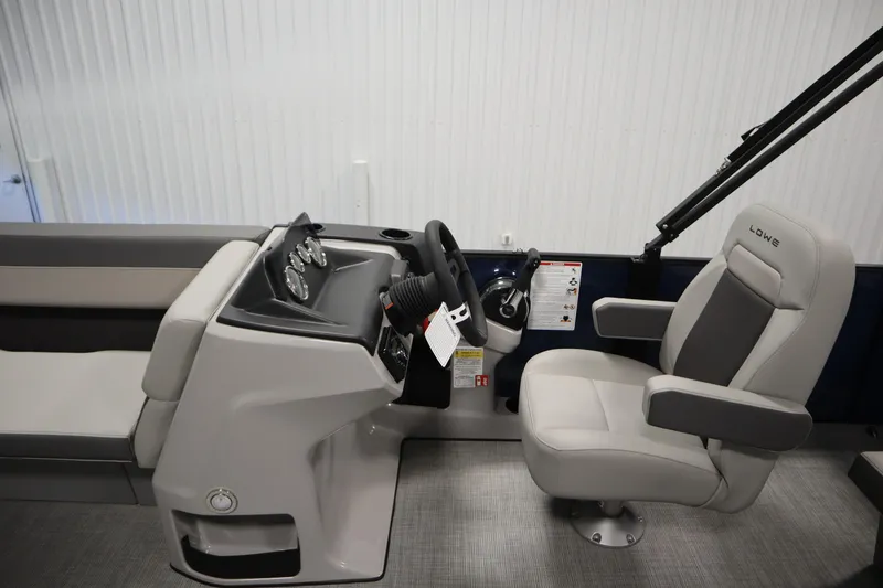 Slide: The Image of 2026 Lowe LS 170 boat interior with steering console and comfortable seating. - 16