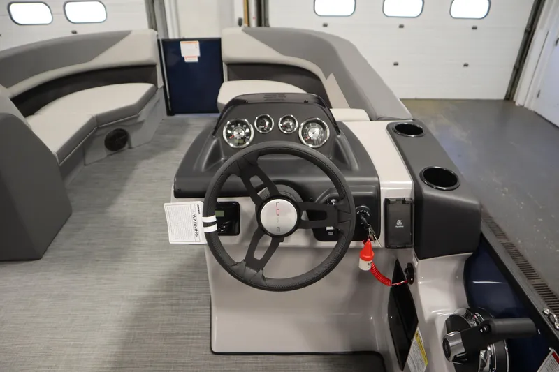 Slide: The Image of 2026 Lowe LS 170 boat interior with steering wheel and seating area. - 17