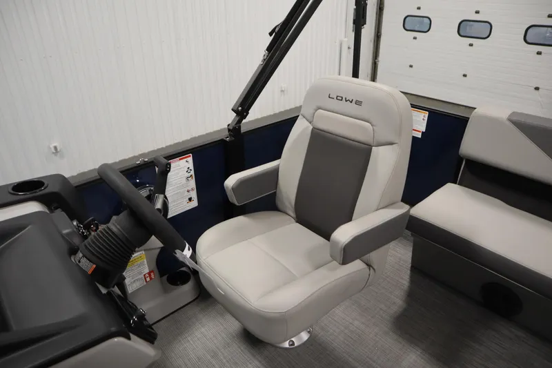 Slide: The Image of 2026 Lowe LS 170 boat interior with steering wheel and comfortable seating. - 24