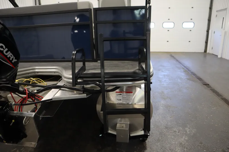 Slide: The Image of 2026 Lowe LS 170 boat with Mercury engine in a garage setting. - 27