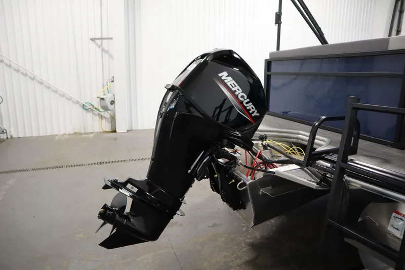 Slide: The Image of 2026 Lowe LS 170 boat with Mercury outboard motor in a garage setting. - 29