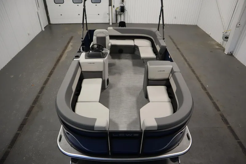 Slide: The Image of 2026 Lowe LS 170 boat interior with spacious seating in a garage setting. - 8