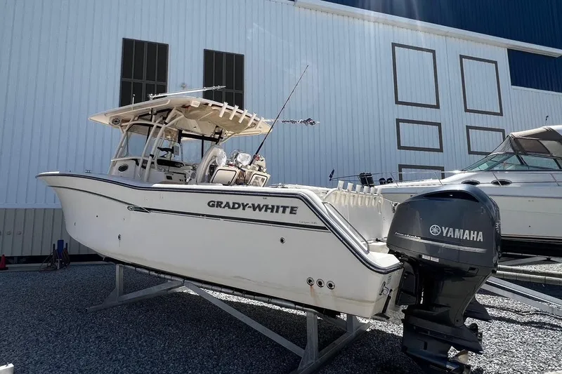 Slide: The Image of 2015 Grady-White Canyon 336 boat with Yamaha engine, displayed outdoors. - 13