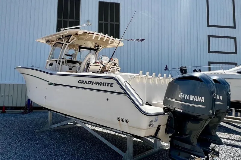 Slide: The Image of 2015 Grady-White Canyon 336 boat with Yamaha engines, displayed outdoors. - 15