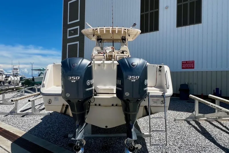 Slide: The Image of 2015 Grady-White Canyon 336 boat with twin Yamaha 350 V8 engines, docked outdoors. - 16